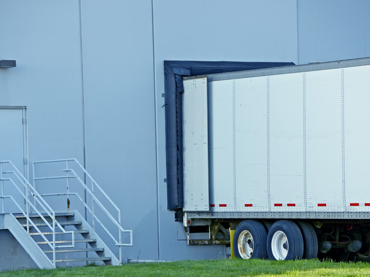 Trailer backed into a warehouse loading bay